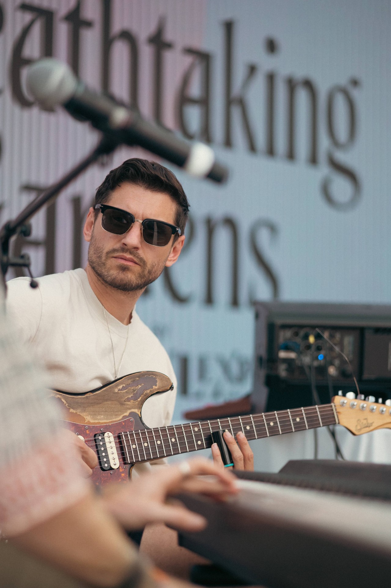 Guitarist in front of the Breathtaking Gardens backdrop